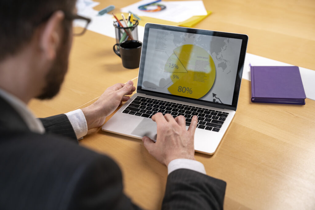 A man analysing traffic growth on the laptop