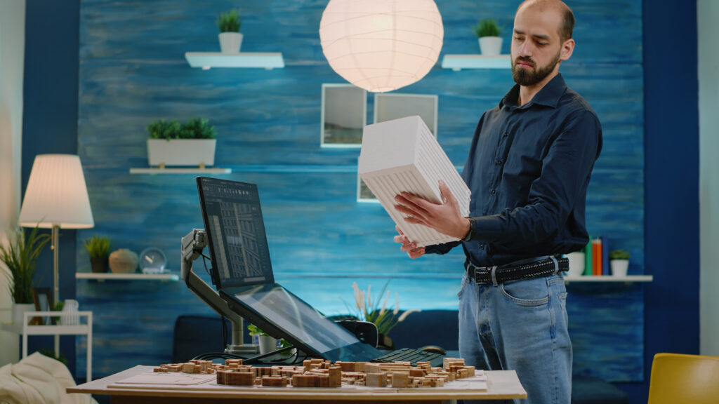 A man working and brainstorming ideas for his electrical business in his office